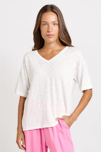 Betty Basics Aries V-Neck Knit Top in White — front view of relaxed cotton-viscose knit top with V neckline and elbow-length sleeves, styled with pink wide-leg trousers.