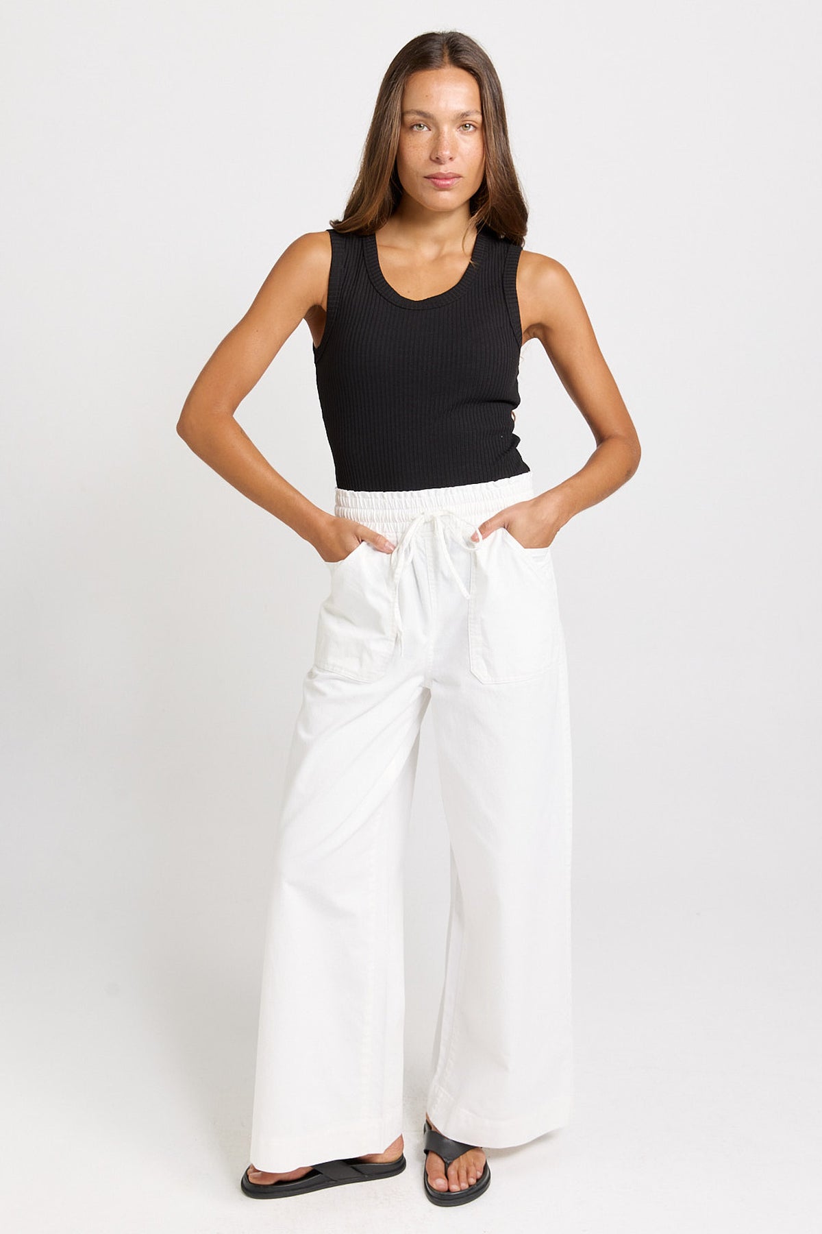 Front view of the Betty Basics Saffra white jeans, showing the elasticated waistband and full-length silhouette with black sandals.