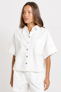Betty Basics Dawn Denim Shirt in white, showing its classic collar, button front and large chest patch pocket.
