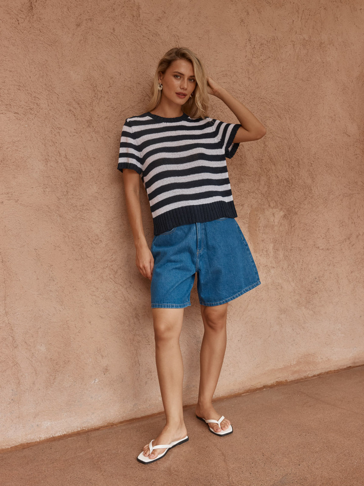 Model wearing the Sass Jules navy and white striped knit tee with denim shorts and white sandals.