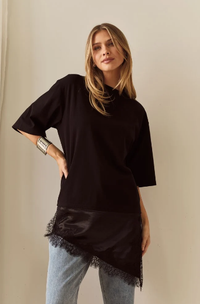 Front view of a model wearing the Sass Arlo Jersey Lace Tee in Black with an asymmetric lace trim, crew neckline and elbow-length sleeves.

