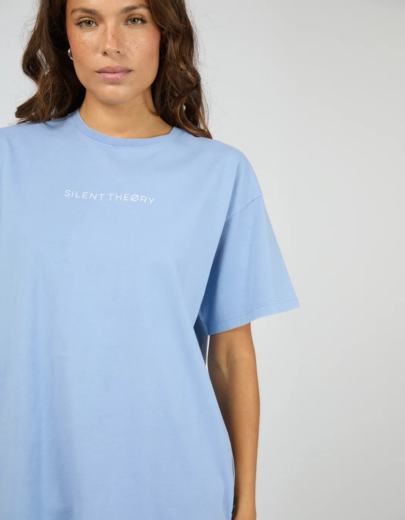 Silent Theory Logo Tee in Light Blue – close-up of white Silent Theory branded chest logo print on soft washed heavyweight light blue cotton jersey fabric

