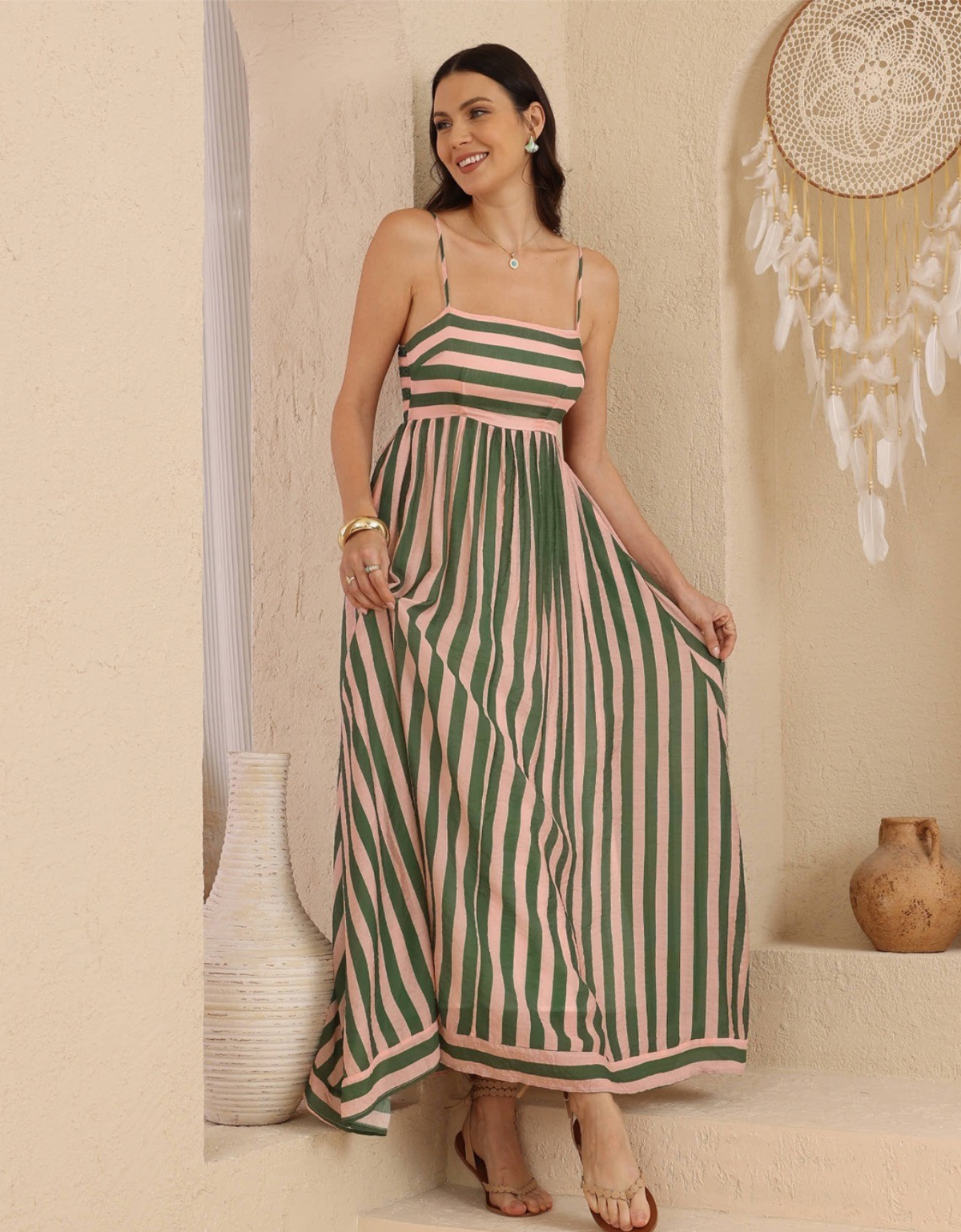 Iris Maxi Ariana Maxi Dress in green and pink stripes, showing fine straps, a horizontally striped bodice and flowing vertically striped skirt.