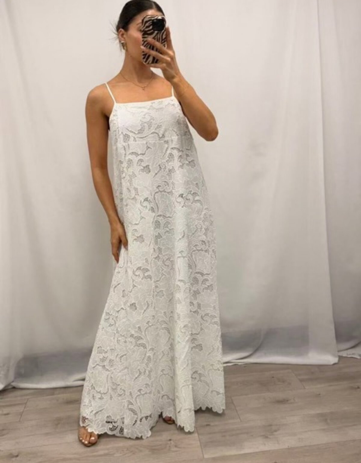 Pink Diamond Lilly Lace Maxi Dress in white, shown from the front with fine shoulder straps, a square neckline, floral lace and a scalloped hem.