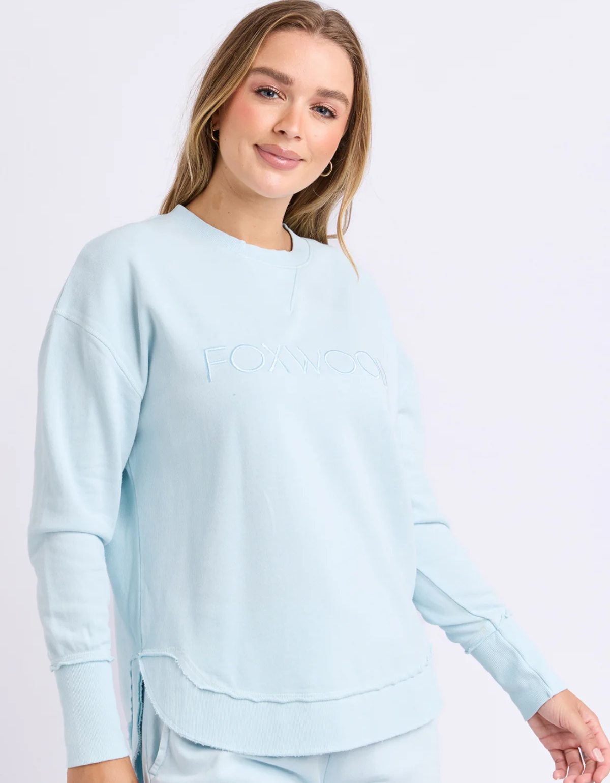 Foxwood Simplified Crew in pale blue, showing tonal chest embroidery, dropped shoulders and a curved raw edge hem.