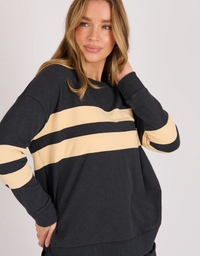 One Ten Willow Panel Stripe Tee in black and beige stripe, front detail on model against a light grey studio background.

