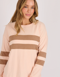 One Ten Willow Panel Stripe Tee in blush and chocolate stripe, front detail on model against a light grey studio background.

