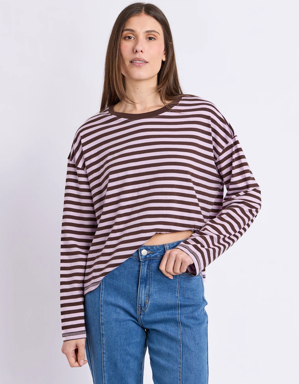 Model wearing the Foxwood Lola Stripe Long Sleeve in lilac and chocolate with blue jeans, front view.