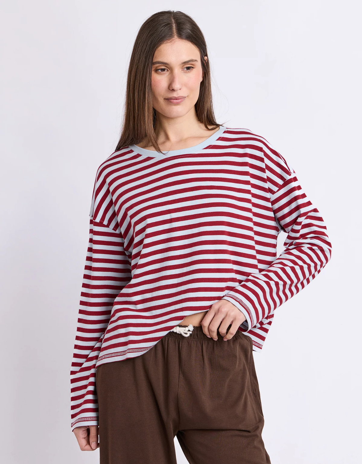 Model wearing the Foxwood Lola Stripe Long Sleeve in Burgundy & Light Blue with brown trousers, front view.