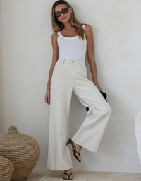 Model wearing the Country Denim Stretch Slouch Jean in sand with a high-rise waist and relaxed wide-leg fit full length front view