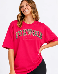 A close up view of a model wearing the Foxwood Interval Leopard Tee in Raspberry/Leopard with a relaxed fit, crew neckline and short sleeves

