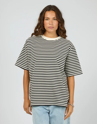 Front view of a model wearing the Silent Theory Stripe Short Sleeve Tee in Black with a relaxed fit and classic crew neckline


