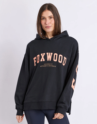 Close up front view of a model wearing the Foxwood Interval Hoodie in Black with Neon Orange, oversized relaxed fit with a classic hood

