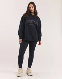 Full length view of a model wearing the Foxwood Metallic Interval Hoodie in Navy with Rose Gold, oversized relaxed fit with a classic hood