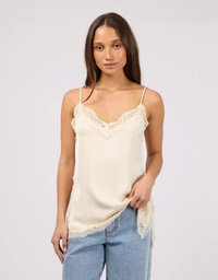 Front view model wearing Silent Theory Carter Lace Trim Cami in Pearl with a relaxed fit and adjustable shoulder straps

