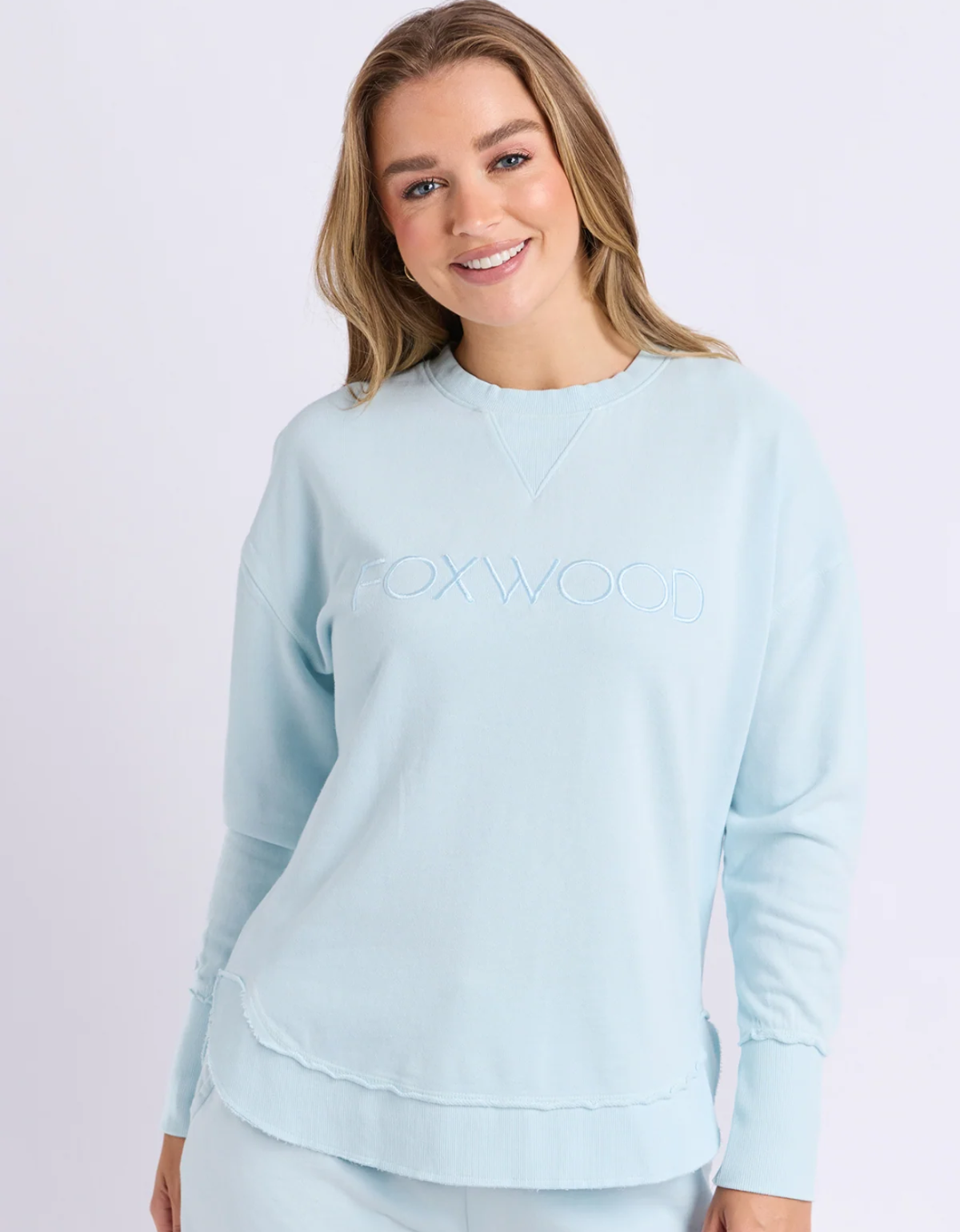 Front view of the pale blue Foxwood Simplified Crew with a round neckline, long sleeves and tonal Foxwood embroidery.