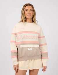 All About Eve Premier Panel Crew Blush - model close up front view showing Varsity League graphic and contrast panel detailing with cream shorts
