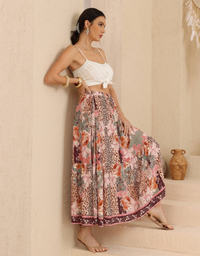 Model wearing the Iris Maxi Missy Maxi Skirt in Leopard Mix Print with pink and coral florals, a white cami and sandals.